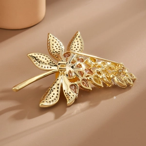 Back view of elegant gold-plated wheat leaf brooch showing needle buckle and fine craftsmanship