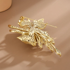 Back view of a gold flower brooch showing high-end craftsmanship and safety pin clasp
