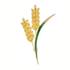Squisita spilla a spiga di grano dorata con zirconi gialli e dettagli in smalto verde