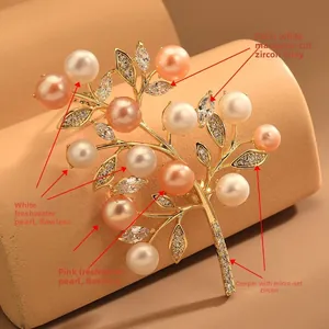 Macro detail of the elegant branch brooch with marquise zircons and freshwater pearls