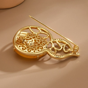 Gourd shaped golden zircon brooch with hollow cloud pattern and amber yellow gemstone