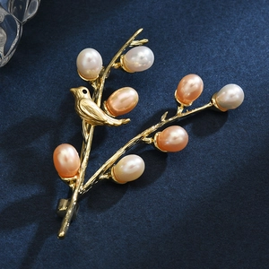 Artistic gold bird on branch brooch featuring colorful natural freshwater pearls