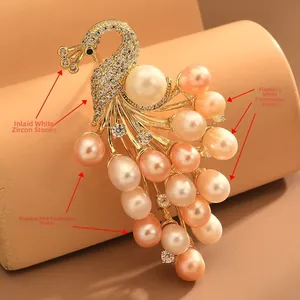 Detailed close-up of golden peacock brooch featuring white and pink freshwater pearls