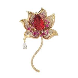 Elegant gold lotus brooch with micro-set zircon and a pear-cut red gemstone drop