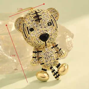 Detailed macro view of gold-toned tiger brooch with measurements 2.2cm x 3.5cm and 7g weight