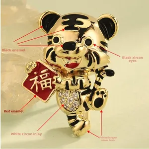 Detail view of gold-plated tiger brooch with enamel accents and white cubic zirconia stones