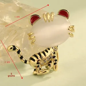 Macro detail of cartoon tiger brooch with cat eye stone, 2.6cm by 2.4cm sizing