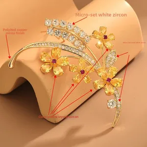 Vue macro d'une broche fleur avec pétales de zircone jaune et cœur de pierre rouge