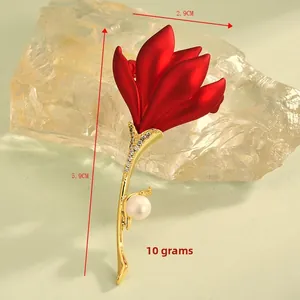 Detail of red tulip brooch with gold stem, pearls, and size dimensions 2.9cm by 5.9cm