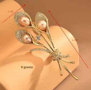 Close-up of golden morning glory brooch with pink pearls and cubic zirconia stones