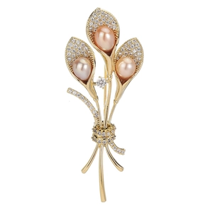 Elegant gold morning glory bouquet brooch with champagne pearls and sparkling zircons