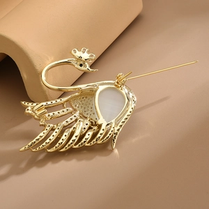 Exquisite gold-plated swan brooch with teardrop gemstone and micro-pave zircon detail