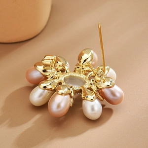 Elegant gold flower brooch with freshwater pearls and cubic zirconia in a radial design