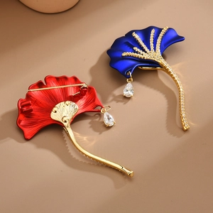 Elegant ginkgo leaf brooches in red and blue with gold plating and drop pendant crystals
