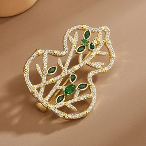 Gold-plated gourd brooch with micro-pave white zircons and marquise green gems