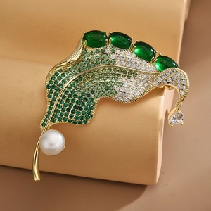 Elegant gold leaf brooch with green crystals, pearls, and drop pendant for women