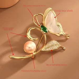 Detailed macro of golden butterfly brooch with mother of pearl and freshwater pearl