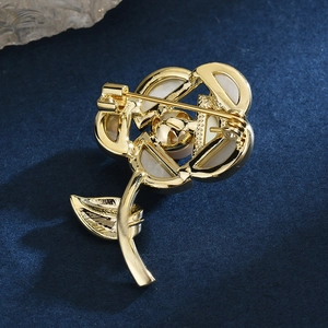 Back view of elegant rose brooch with gold pin mechanism and mother of pearl petals