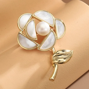 Elegant gold camellia flower brooch with white shell petals and a pearl accent