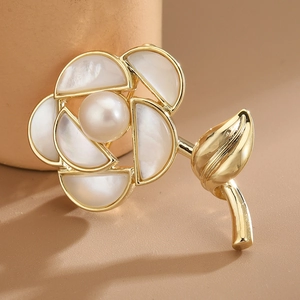 Elegant rose brooch with white mother of pearl petals and a round freshwater pearl center
