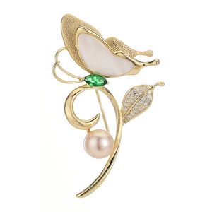 Elegant butterfly brooch with mother of pearl wings and a freshwater pearl accent