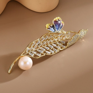 Elegant gold leaf brooch with blue butterfly and white pearl in zirconia setting