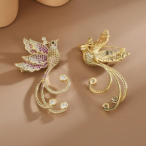 Elegant gold phoenix brooch with vibrant crystals shown in front and back view