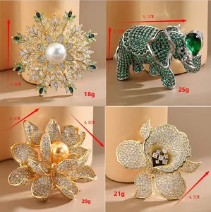 Detailed views of luxury lotus and elephant brooches with pearls and zircons