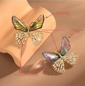 Macro detail of elegant butterfly brooches with green and purple synthetic wings