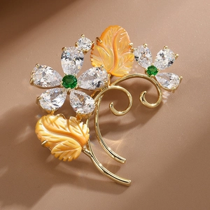 Elegant gold flower brooch with sparkling zircon petals and carved amber shell leaves