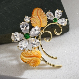Vintage gold brooch with zircon flower and amber resin leaves on stone base