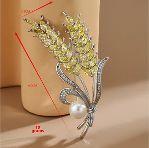 Detail showing wheat stalk brooch dimensions of 6.0cm by 3.3cm with micro-set zircon stones