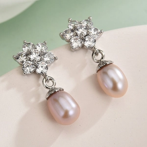Elegant flower earrings with pink pearl pendants and sparkling zircon in a refined style