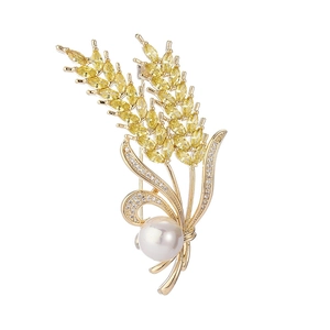 Elegant wheat ear brooch with gold finish, yellow zircon grains, and a large white pearl
