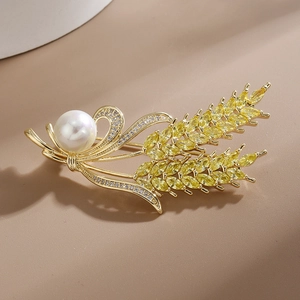 Elegant gold wheat brooch featuring a large white pearl and sparkling zircon stones
