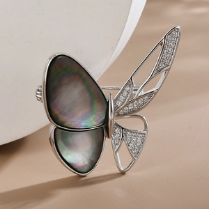 Elegant butterfly brooch with dark iridescent mother of pearl and white zircon crystals