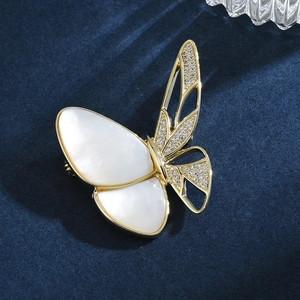 Elegant gold butterfly brooch with shimmering mother of pearl and zircon stones