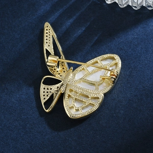 Elegant butterfly brooch with gold metal frame, white mother-of-pearl and zircon accents