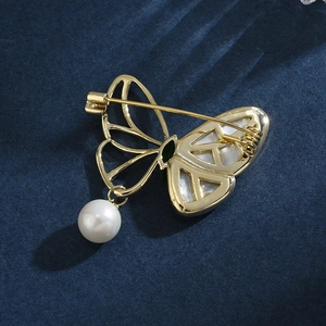 Elegant gold butterfly brooch with mother of pearl, pearl pendant, back pin detail view