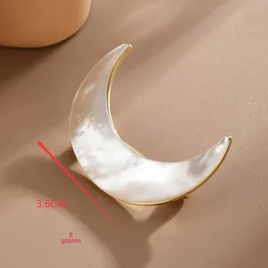Detail shot of crescent shell brooch in gold frame with 3.6cm size and 8g weight