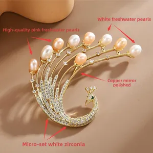 Macro detail of gold peacock brooch with freshwater pearls and sparkling zircons