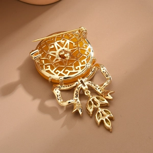 Exquisite bow brooch with amber-colored gemstone and micro-set cubic zirconia details