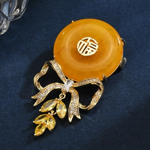 Elegant Chinese bow brooch with Fu character, amber resin, and yellow zircon crystals