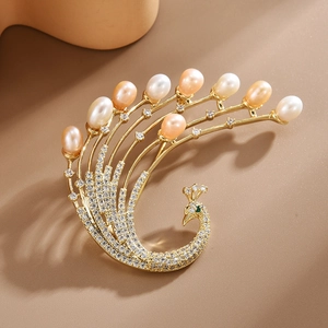 Elegant gold phoenix brooch with shimmering cubic zirconia and freshwater pearls