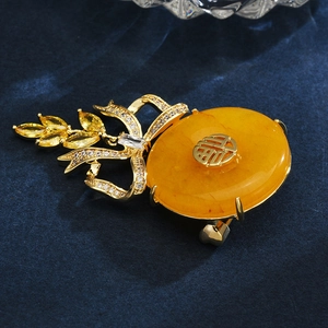 Exquisite gold bow brooch with Fu character, yellow amber and micro-set zircon accents