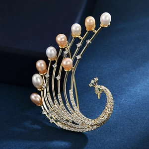 Exquisite phoenix brooch with freshwater pearls and sparkling zircons on blue background