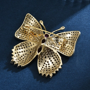 Broche papillon élégante en métal doré avec une pierre centrale en zircon violette