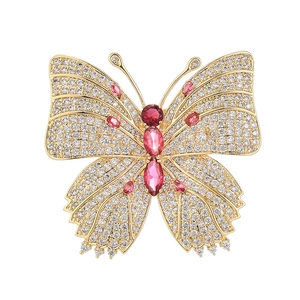 Exquise broche papillon en métal doré avec zircons rouges étincelants incrustés