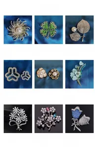 Detailed grid of vintage camellia and floral brooches with pearls and zircons