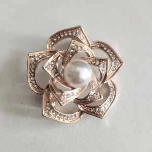 Elegant rose gold camellia brooch with crystal petals and a central white pearl